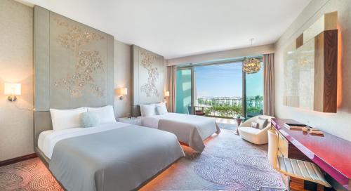 a hotel room with two beds and a window at W Singapore - Sentosa Cove in Singapore
