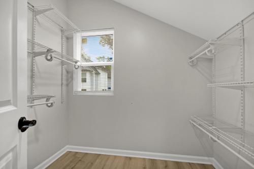 a white room with shelves and a window at Near Park Circle, Downtown, And Beaches in Charleston
