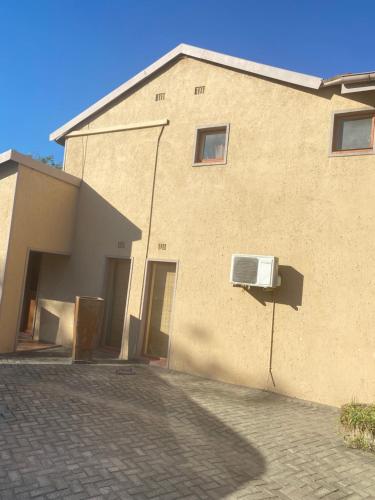 a building with a air conditioner on the side of it at Texas Phalaborwa guesthouse in Phalaborwa