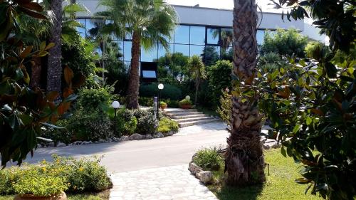 a palm tree in front of a building at Tursport in Taranto