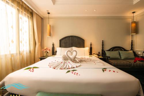 a bedroom with a bed with a heart decoration on it at Hanoi Emerald Waters Hotel Valley in Hanoi