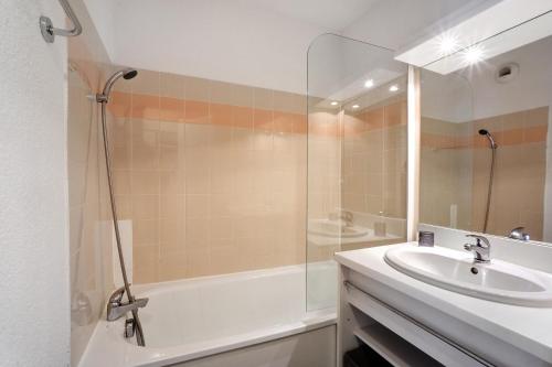 a bathroom with a tub and a sink and a shower at A3 405 Appart au pied des pistes in Saint-François-Longchamp