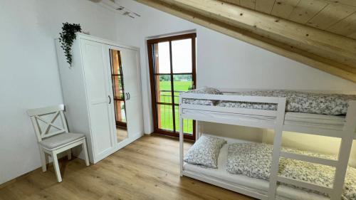 a room with two bunk beds and a chair at Ferienwohnung Weitsicht in Halblech