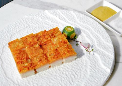 a white plate with a piece of food on it at Le Meridien Suzhou, Suzhou Bay in Suzhou