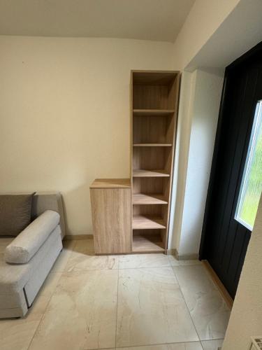 a living room with a couch and a book shelf at Apartmán Komenského 14 in Prievidza