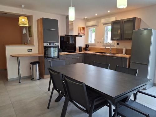 a kitchen with a table and chairs in it at Gite du Clos de Givrais in Jarnioux