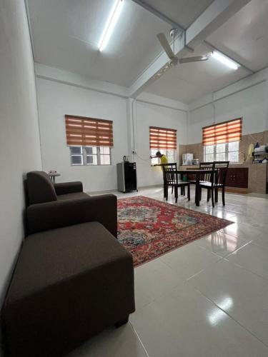 a living room with a couch and a table at Nick Cozy Homestay 1st Floor in Jeli
