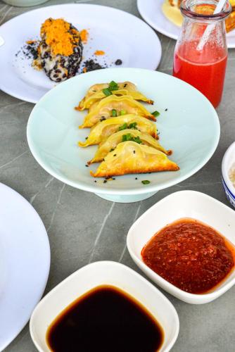 a table topped with plates of food and sauce at Le Meridien Suzhou, Suzhou Bay in Suzhou