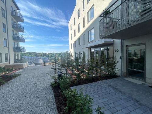 a building with a walkway next to a building at Newly built bright apartment, close to everything If you want to visit Stockholm, you will find the perfect accommodation here! Ferry line 80 makes it very convenient and easy to get to the city center in Nacka