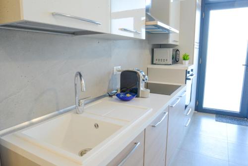 a kitchen counter with a sink and a sink at Sopra le Onde VADOALMARE Immobiliare in Vado Ligure