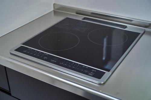 a tablet computer sitting on top of a stove at Refwind in Kyonan