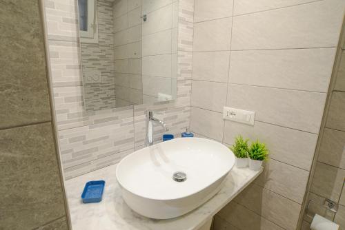 a bathroom with a white sink and a mirror at Sopra le Onde VADOALMARE Immobiliare in Vado Ligure