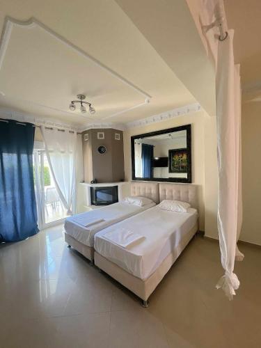 a large white bedroom with a large bed in it at Apartments Alexandros in Polykhrono