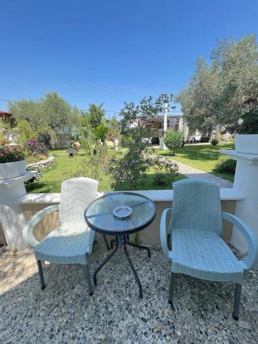 two chairs and a table on a patio at Apartments Alexandros in Polykhrono