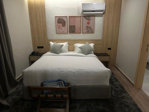 a bedroom with a large white bed in a room at Lacasa Residence in Cairo