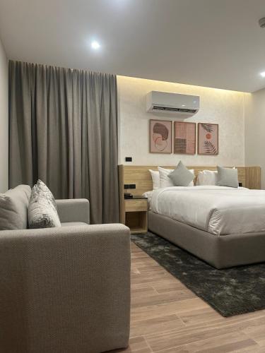 a hotel room with a bed and a couch at Lacasa Residence in Cairo