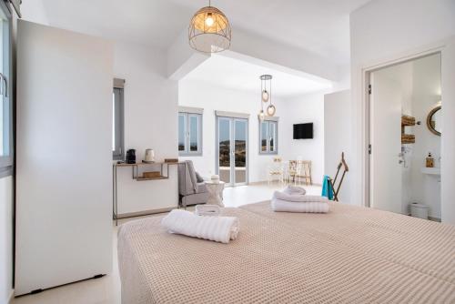 a white room with a large bed with two pillows at Villa Anastasio in Kampos Paros