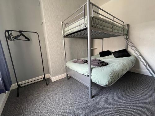 a bedroom with a bunk bed with a ladder at Beautiful 2 bedroom property with 5G WI-FI in Hull