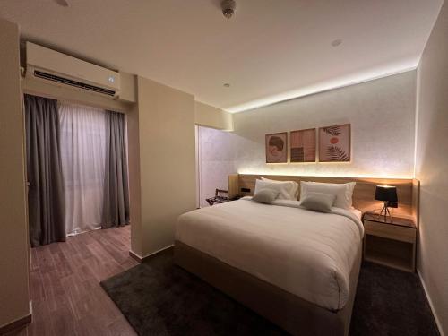 a hotel room with a large bed and a window at Lacasa Residence in Cairo