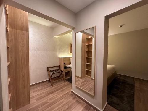 a small room with a mirror and a bedroom at Lacasa Residence in Cairo