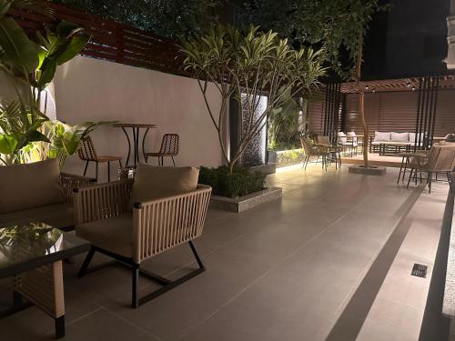 a patio with chairs and tables and plants at Lacasa Residence in Cairo