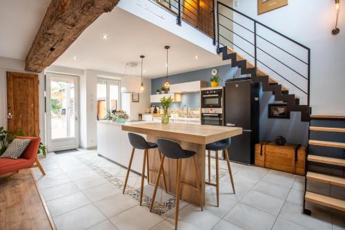 une cuisine avec une table en bois et un escalier dans l'établissement Gîte 11 personnes Vallée du loir, à Villiers-sur-Loir