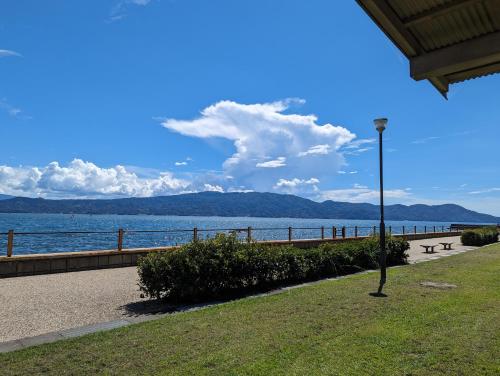 a view of a body of water with a street light at private rooms in togo beach and park side house in Numazu