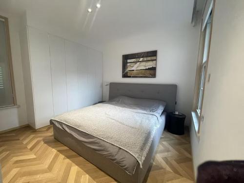 a small bedroom with a bed and a picture on the wall at Stanford Garden in Shanghai