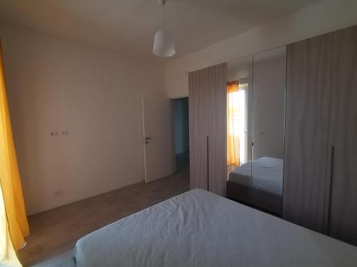 an empty bedroom with a bed and a window at Case Vacanza Dimo Dimira - SALENTO & RELAX in Torre Chianca