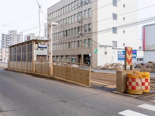 a fence on the side of a city street at Gran Palette Hakodate in Hakodate