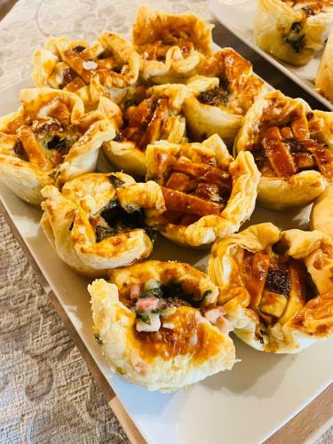 a plate of food with pies on a table at Agri-alloggio le Poscole Al Canton in Castelgomberto