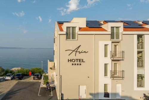 a hotel with a sign on the side of it at Hotel Aria in Podstrana