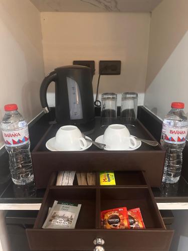 a box with a coffee maker and water bottles at Lacasa Residence in Cairo