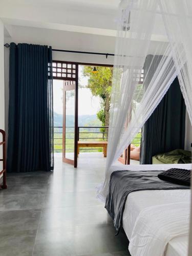 a bedroom with a bed with a view of the ocean at Idyll Cottage Ella in Ella