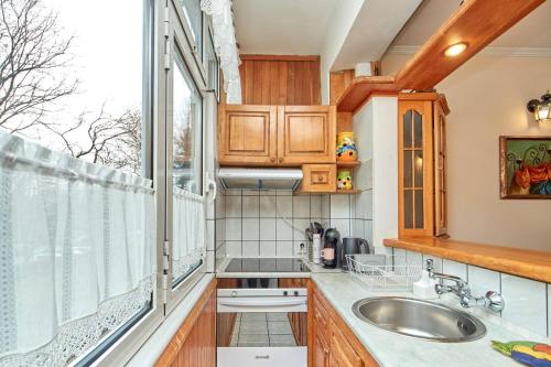 a kitchen with a sink and a window at Апартамент Бриз in Burgas