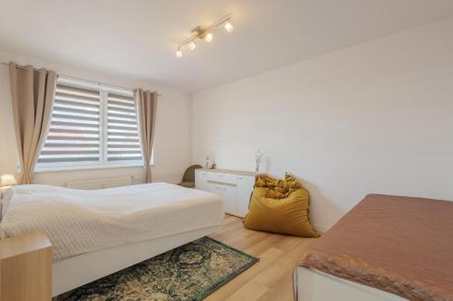 a bedroom with a bed and a window at Apartmán Tatry Lesná in Nová Lesná
