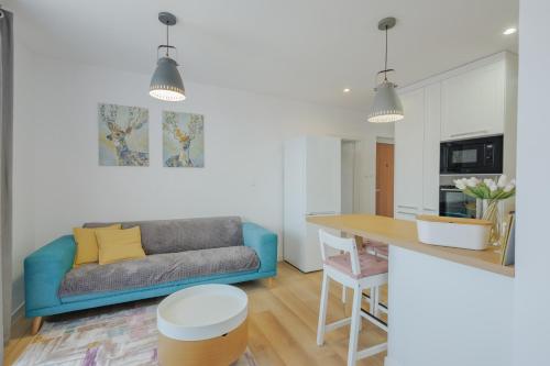 a living room with a couch and a table at Apartmán Tatry Lesná in Nová Lesná