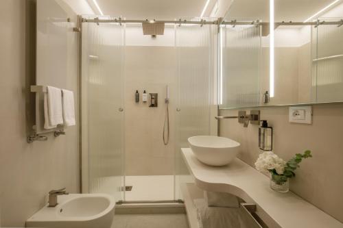 a white bathroom with a sink and a shower at Boutique Hotel Campo de' Fiori in Rome