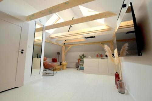 a living room with a ceiling with skylights at Apartamenty Blanca in Łeba