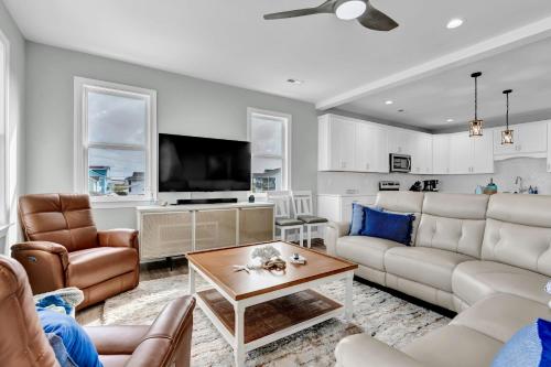 a living room with a couch and a table at Seaside Serenity Beautiful Home on Topsail 7 BR in Surf City