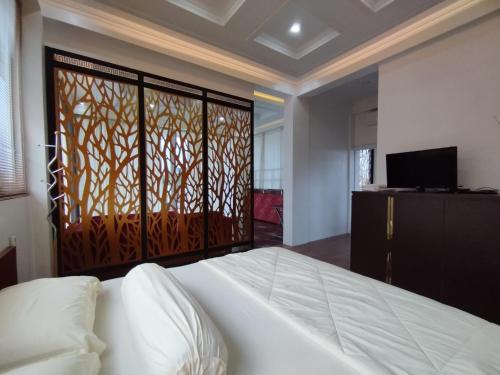 a bedroom with a bed and a sliding glass door at Saira Hotel dan Homestay Syariah in Sleman
