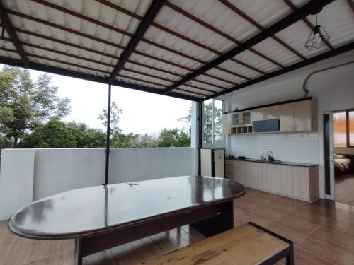 a kitchen and dining room with a glass table at Saira Hotel dan Homestay Syariah in Sleman