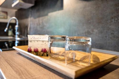 a wooden cutting board with two jars on a counter at Wünsch Dir was in Großweitzschen