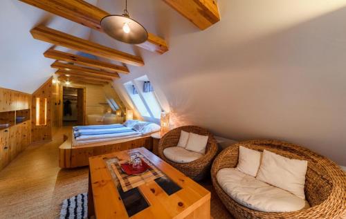 a living room with a bed and a table at Penzion Ovečka in Nýdek