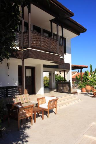 a patio with chairs and a balcony on a house at Villa Konak Hotel in Kusadası