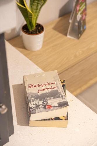 a stack of books sitting on top of a counter at Relax house by the sea in Volos