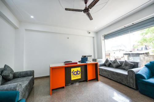 a living room with a couch and a table at FabHotel The Yashobhumi Near Yashobhoomi Convention Centre in New Delhi