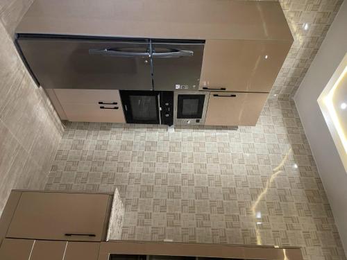 an overhead view of a kitchen with a microwave at Charming 3-Bed House in Kubwa in Kaba