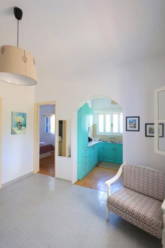 a living room with blue cabinets and a couch at Verde in Lipsoi