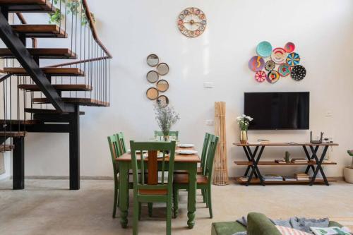 a dining room with a table and chairs and a tv at Nistula Luxury Villa with Private Pool in Assagao in Assagao